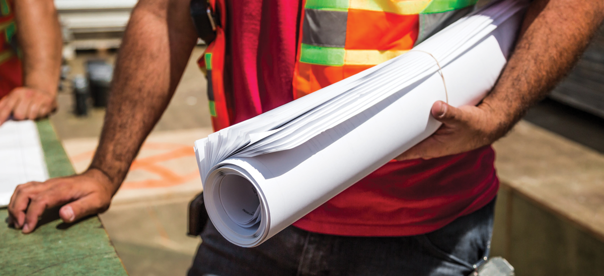 Construction Man Holding Plans